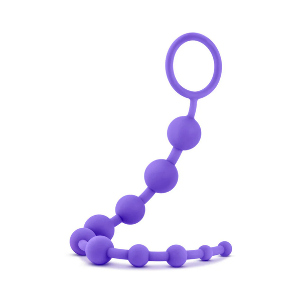 Front view of the purple silicone anal bead strand upright on a white surface. The flexible strand curves gracefully, displaying 10 beads increasing in size toward the top retrieval ring.