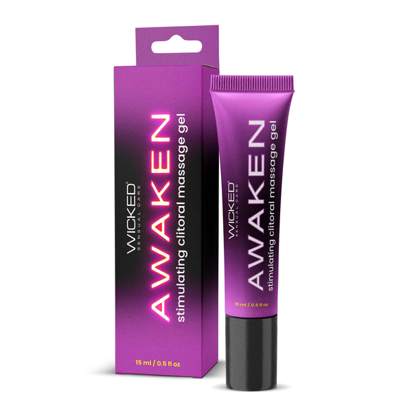 A product shot of the new packaging for Wicked "Awaken" stimulating clitoral massage gel against a plain white background. It features a rectangular box on the left and a squeeze tube on the right. Both share a vibrant purple and black color scheme with the word "AWAKEN" printed vertically in a glowing pink font, followed by the text "stimulating clitoral massage gel" and the volume "15 ml / 0.5 fl oz" near the bottom.