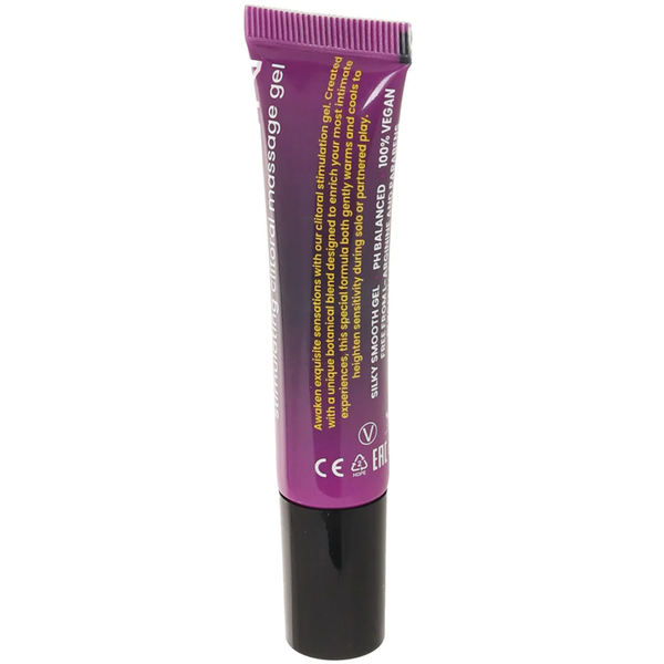 A close-up shot of the back of the "Awaken" stimulating clitoral massage gel tube against a white background. The yellow text describes the product as a "botanical blend designed to enrich your most intimate experiences." Below the description, key features are highlighted, including "SILKY SMOOTH GEL," "pH BALANCED," and "100% VEGAN," alongside standard manufacturing icons, a "V" vegan symbol, and a recycling logo.