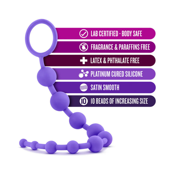 An infographic overlaying purple feature banners onto the silicone bead strand. Highlighted features include "Lab Certified - Body Safe," "Platinum Cured Silicone," "Satin Smooth," and "10 Beads of Increasing Size."