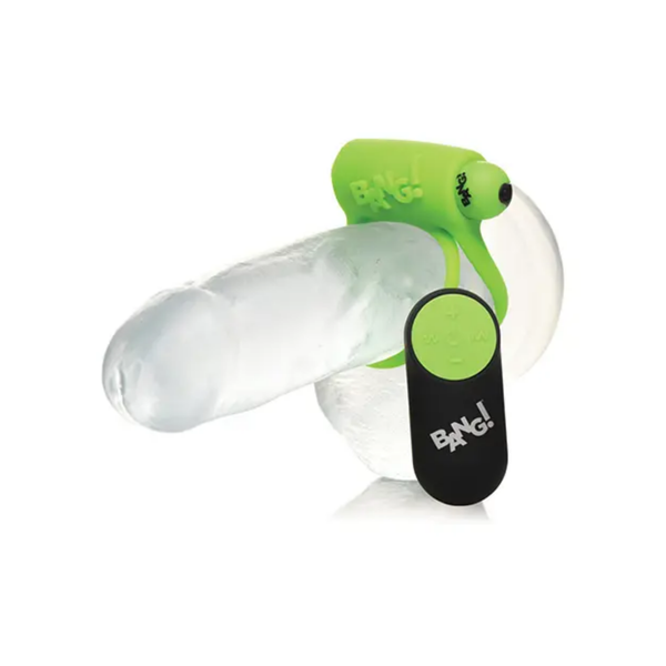 Demonstration shot showing the neon green c-ring fitted onto a clear anatomical model alongside its wireless remote control.