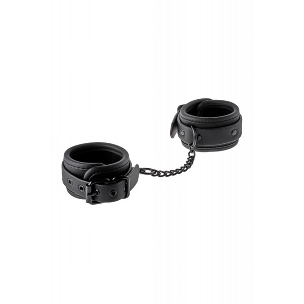 A pair of black, Blaze Luxury Fetish HandCuffs connected by a short metal chain, resting open.