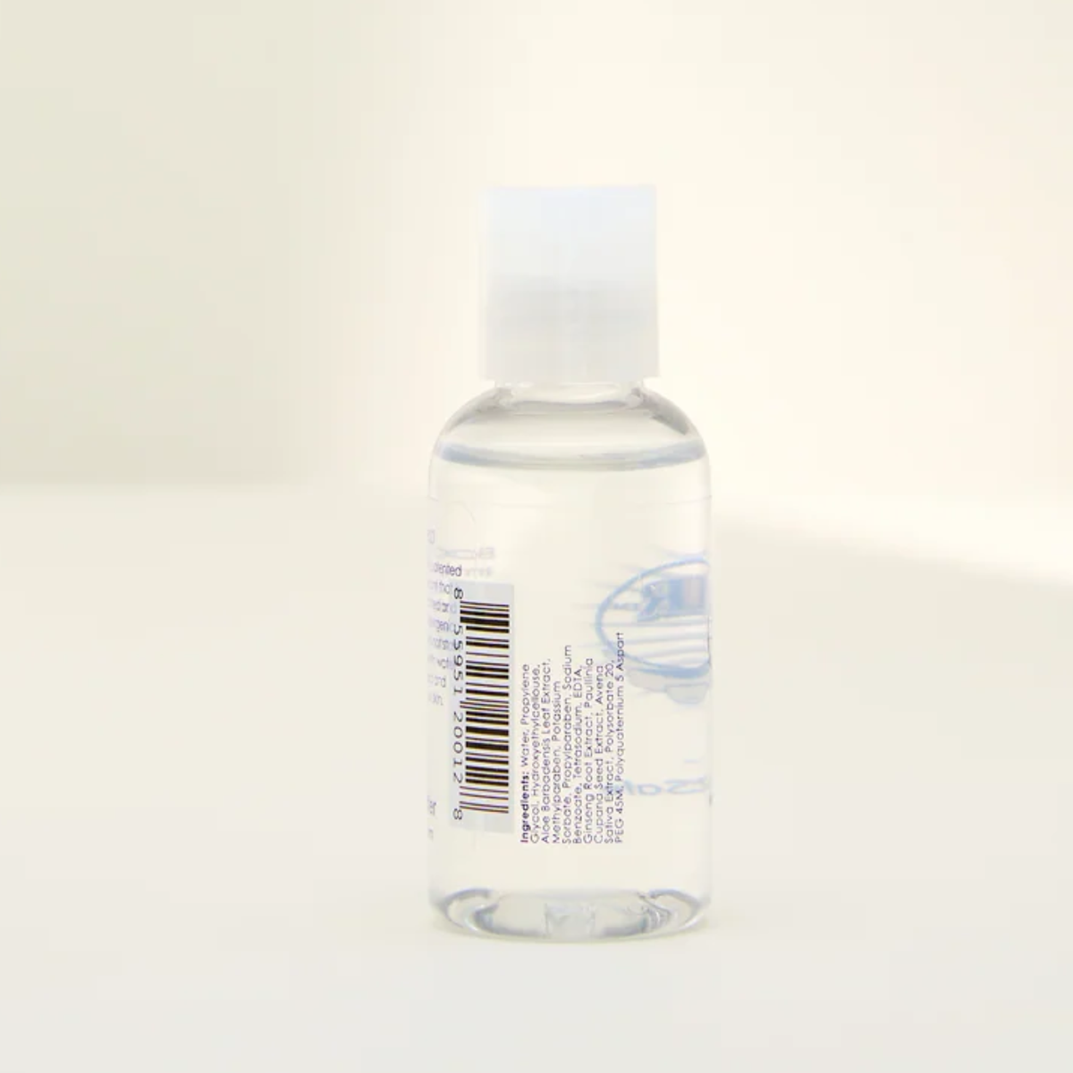 Opposite side view of the Boy Butter CLEAR lubricant bottle, displaying the white ingredients list printed vertically on the clear label next to the barcode.