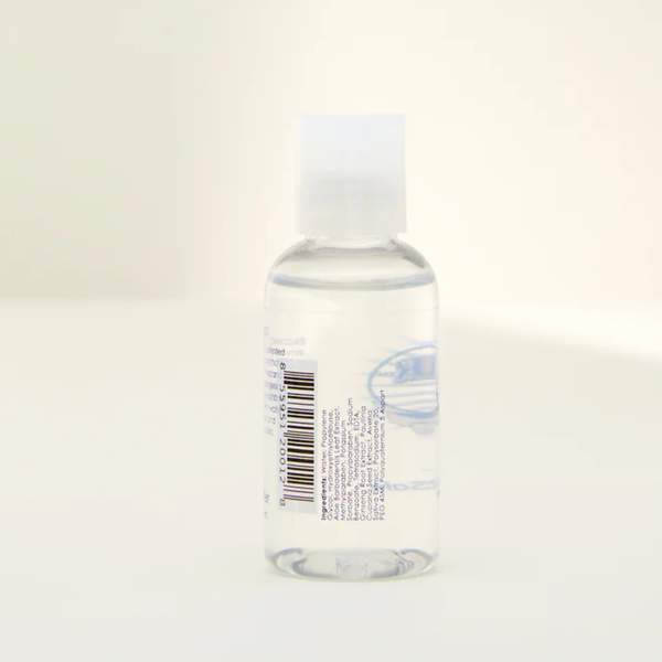 Opposite side view of the Boy Butter CLEAR lubricant bottle, displaying the white ingredients list printed vertically on the clear label next to the barcode.