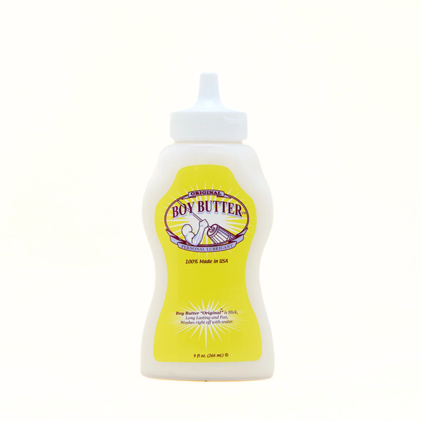 A shot of the front of the Boy Butter Original Personal Lubricant. The white, contoured, squeeze bottle has a white nozzle and a yellow label featuring the "Boy Butter" logo with a stylized image of a person churning butter, and text stating "ORIGINAL PERSONAL LUBRICANT" and "100% Made in USA."