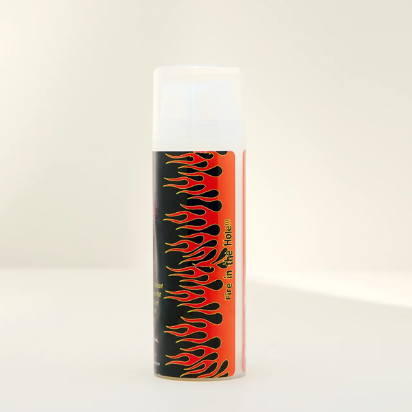A side view of Boy Butter Warming lubricant, with caption "Fire in the hole", indicating its warming effect.