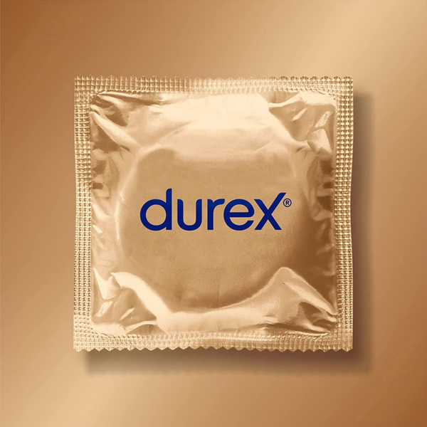 A top-down, centered shot of a single, square Durex Sensual XL condom wrapper. The wrapper is made of crinkled, metallic gold foil with serrated edges for easy opening. The blue Durex logo is printed horizontally across the center. The wrapper is set against a soft, gradient gold background that matches its metallic sheen.