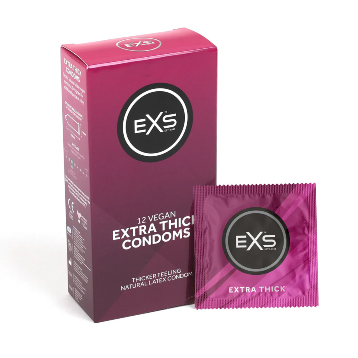 Studio product shot showing the magenta box of EXS 12 Vegan Extra Thick Condoms standing next to a single sealed magenta foil wrapper against a plain white background. Main image