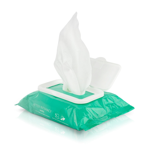 Product demonstration shot showing a single white wet wipe extending upward from the open flip-top lid of the green EasyGlide pack.