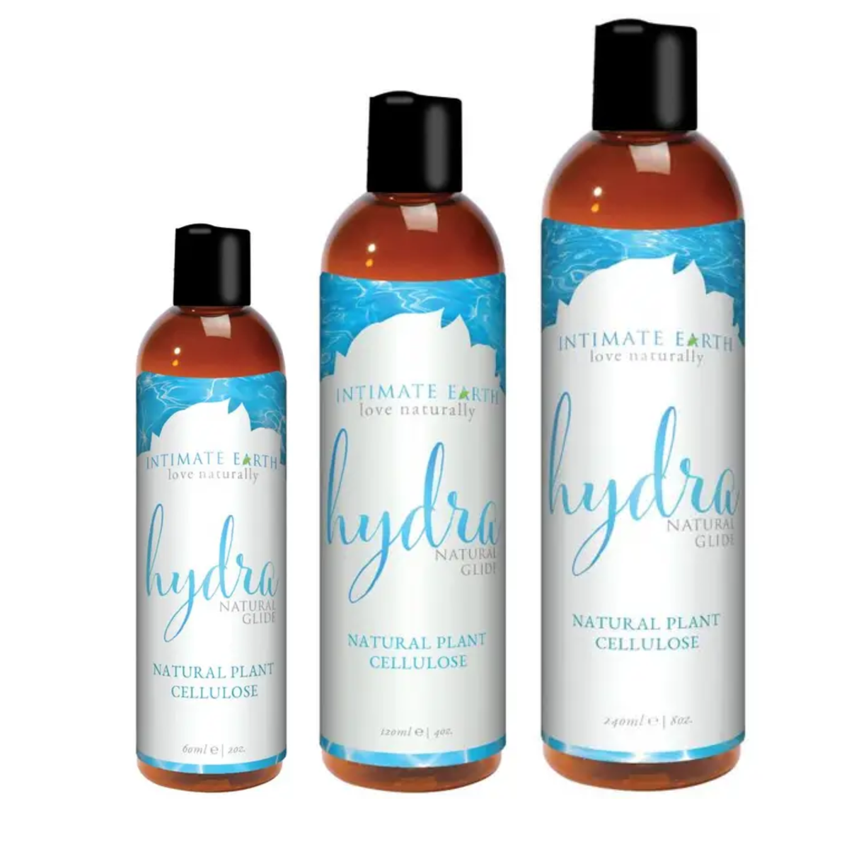 Size comparison view showing three amber bottles of Intimate Earth Hydra natural plant cellulose glide standing side by side in 60 ml (2 fl oz), 120 ml (4 fl oz), and 240 ml (8 fl oz) capacities. Main image