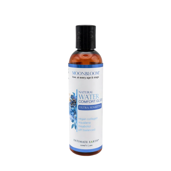 Front studio view of the 120 ml (4 fl oz) amber bottle of Intimate Earth Moon Bloom natural water comfort glide for extra sensitive skin, highlighting vegan collagen, squalene, and bisabolol ingredients.
