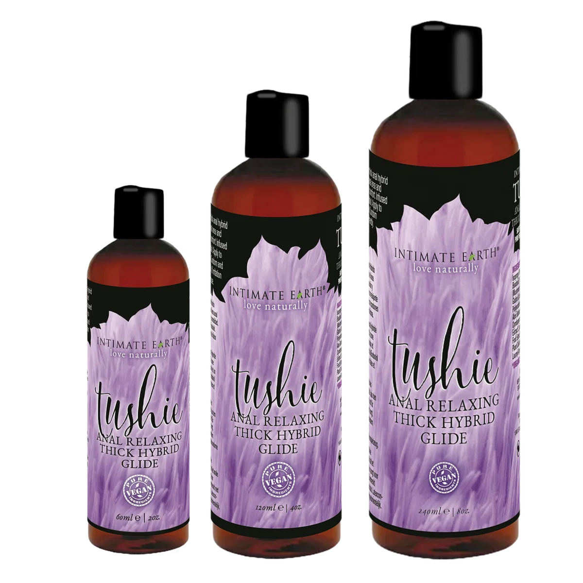 Size comparison view showing three amber bottles of Intimate Earth Tushie thick hybrid glide standing side by side in 60 ml (2 fl oz), 120 ml (4 fl oz), and 240 ml (8 fl oz) capacities. Imagen principal del producto