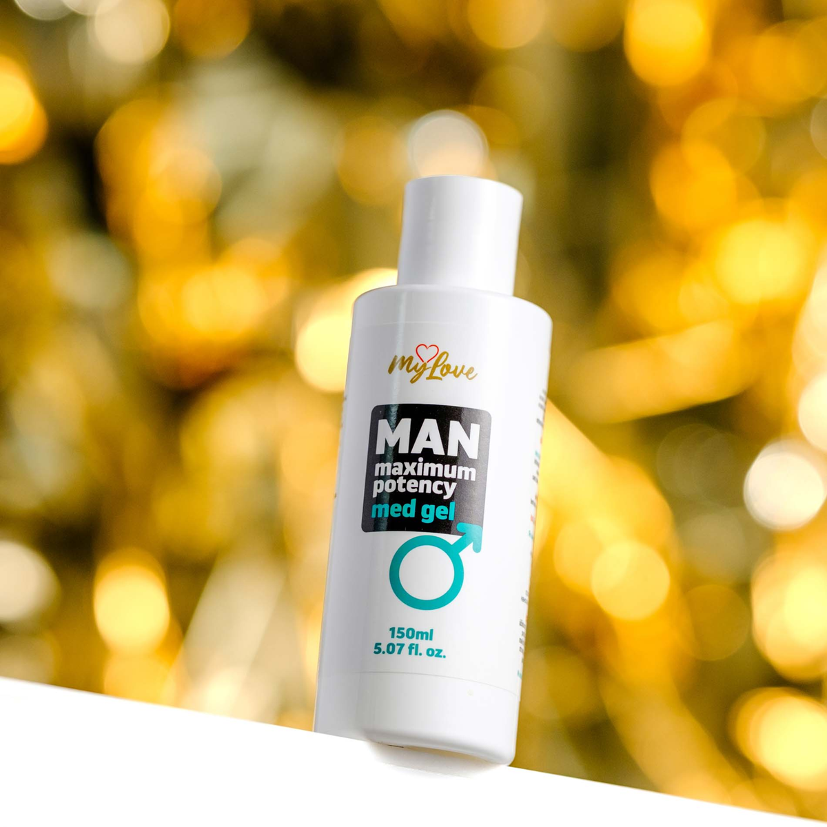 Front view of the 150 ml MyLove Man Maximum Potency Med Gel bottle set against a warm, heavily blurred golden bokeh lighting background.