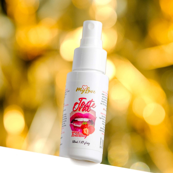 Front view of the 50 ml MyLove Taste Oral Spray bottle set against a warm, heavily blurred golden bokeh lighting background.