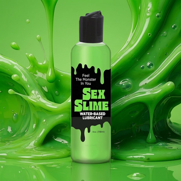 Action studio view of the 4 oz (118 ml) green squeeze bottle of Sex Slime Water-Based Lubricant with a black drippy-style label reading "Feel The Monster In You", set against a dynamic splash of glossy green slime