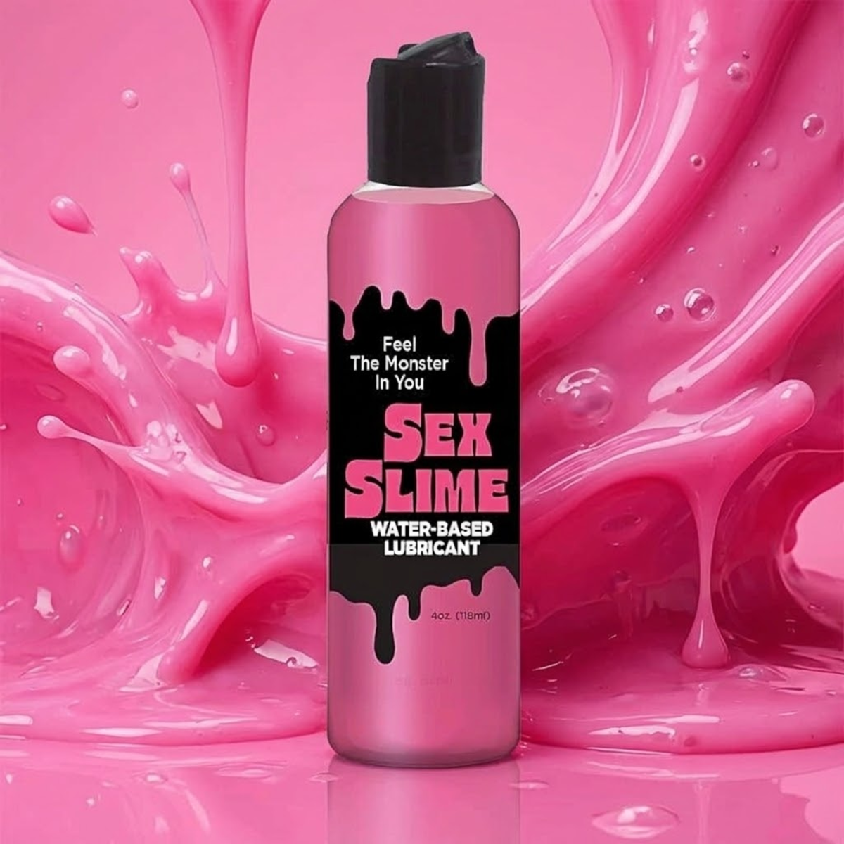 Action studio view of the 4 oz (118 ml) pink squeeze bottle of Sex Slime Water-Based Lubricant with a black drippy-style label reading "Feel The Monster In You", set against a dynamic splash of glossy pink slime.