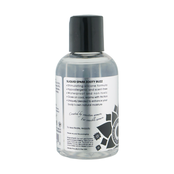 Back label view of the clear bottle detailing product features for Sliquid Spark Booty Buzz, including its stimulating silicone formula, hypoallergenic qualities, and friction-activated warming.