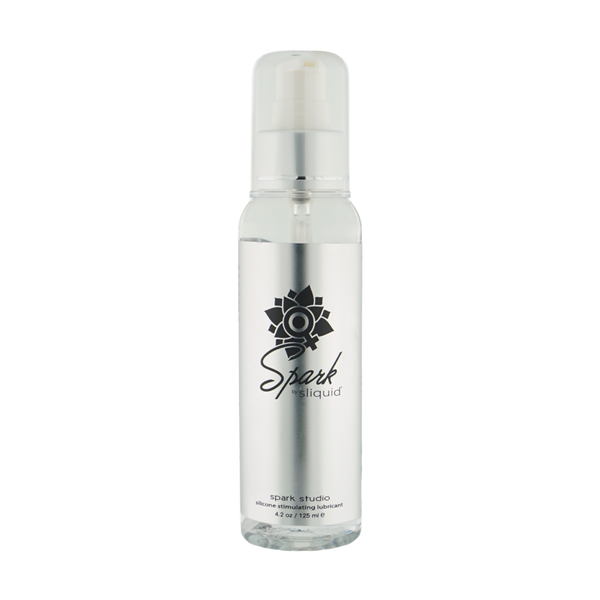 Front studio view of the clear 4.2 fl oz (125 ml) pump bottle of Sliquid Spark Studio silicone stimulating lubricant with a metallic silver label and clear cap.