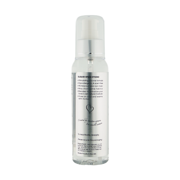 Back label view of the clear pump bottle detailing product benefits, including stimulating silicone formula, hypoallergenic properties, friction-activated warming, and usage directions.