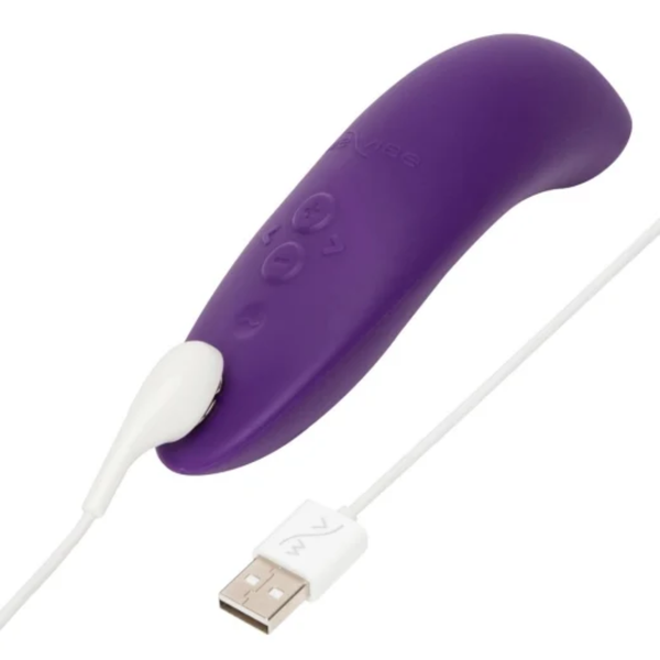 Close-up view of the purple We-Vibe Melt 2 massager connected to its white magnetic USB charging cable.
