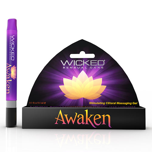 A product shot of the old packaging for Wicked "Awaken" stimulating clitoral massage gel against a plain white background. It features a rectangular box on the right and a squeeze tube on the left. Both share a vibrant purple and black color scheme with the word "AWAKEN".